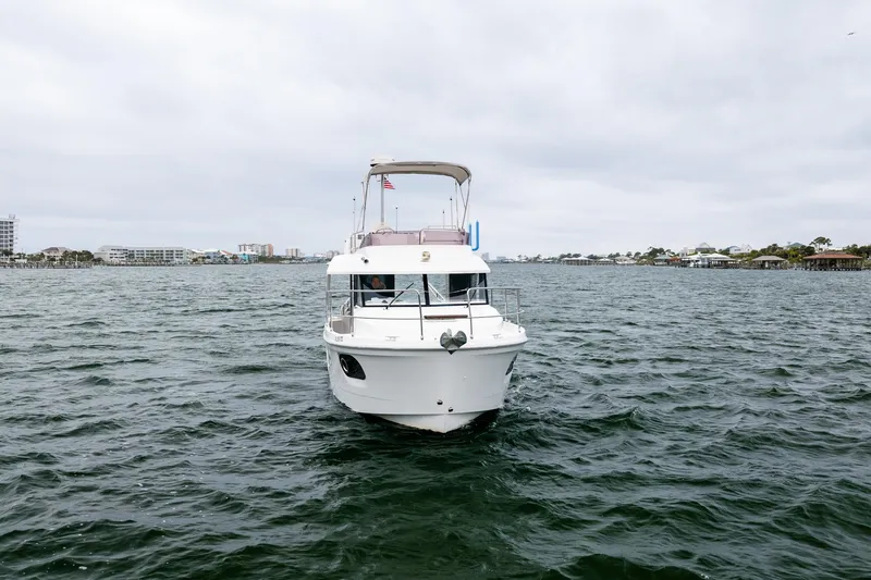 Slide: The Image of 2018 Beneteau Swift Trawler 30 cruising on open water under cloudy skies. - 73
