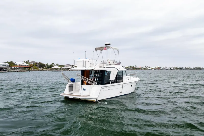Slide: The Image of 2018 Beneteau Swift Trawler 30 cruising on a calm coastal waterway. - 74