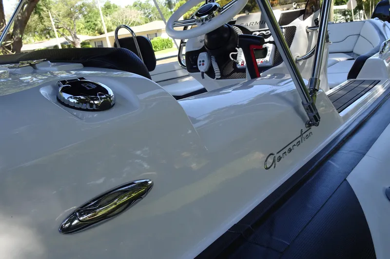 Slide: The Image of 2022 Walker Bay Generation 525 boat interior with steering wheel and seating. - 10