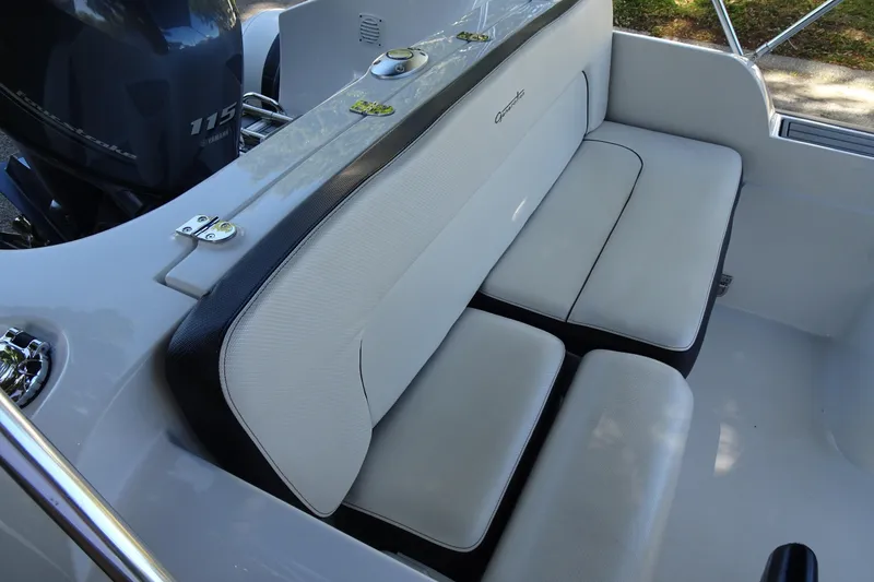 Slide: The Image of 2022 Walker Bay Generation 525 boat interior with cushioned seating and Yamaha 115 engine. - 14