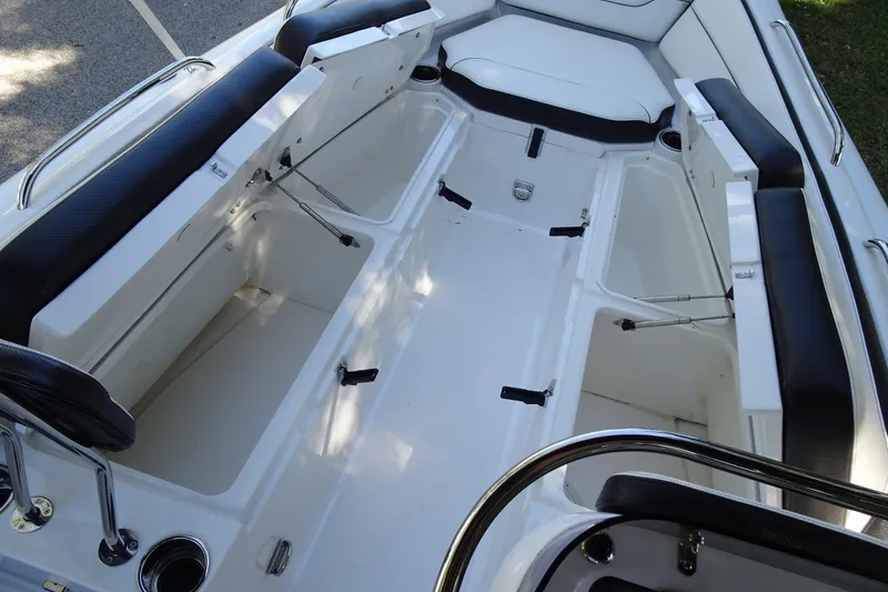 Slide: The Image of 2022 Walker Bay Generation 525 boat interior with open storage compartments and seating. - 17