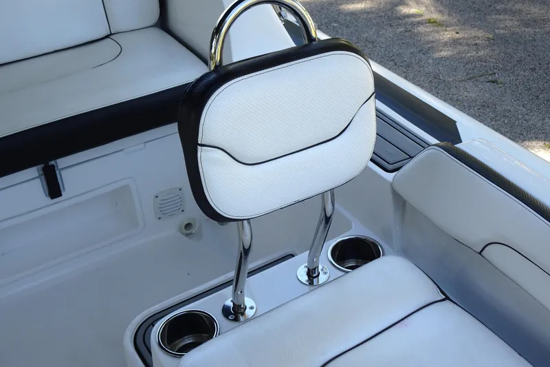 Slide: The Image of 2022 Walker Bay Generation 525 boat interior with white seating and cup holders. - 18