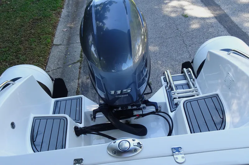 Slide: The Image of 2022 Walker Bay Generation 525 boat with Yamaha 115 outboard motor, docked on pavement. - 19