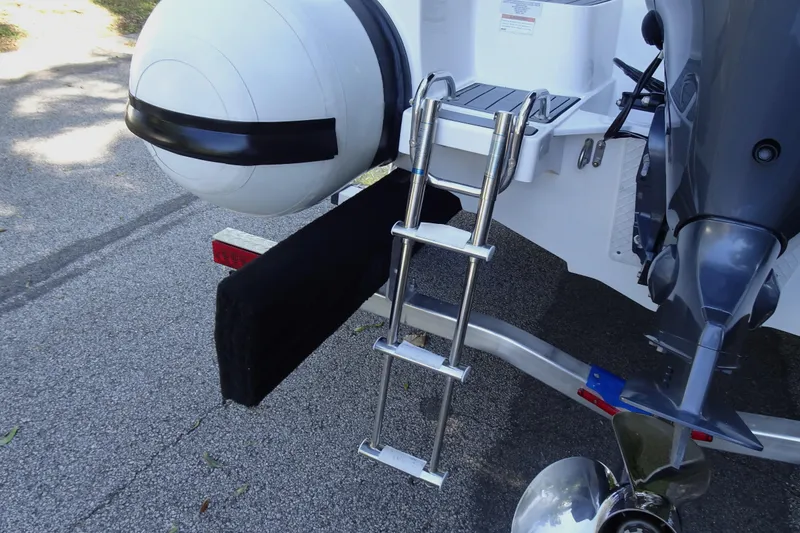 Slide: The Image of Walker Bay Generation 525 boat, 2022 model, featuring a rear ladder and motor. - 20