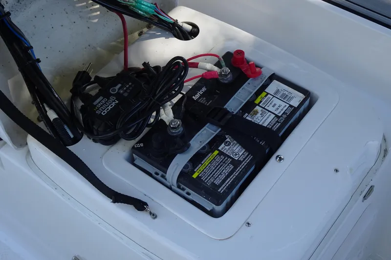 Slide: The Image of Battery compartment of 2022 Walker Bay Generation 525 boat, featuring marine battery and wiring. - 24