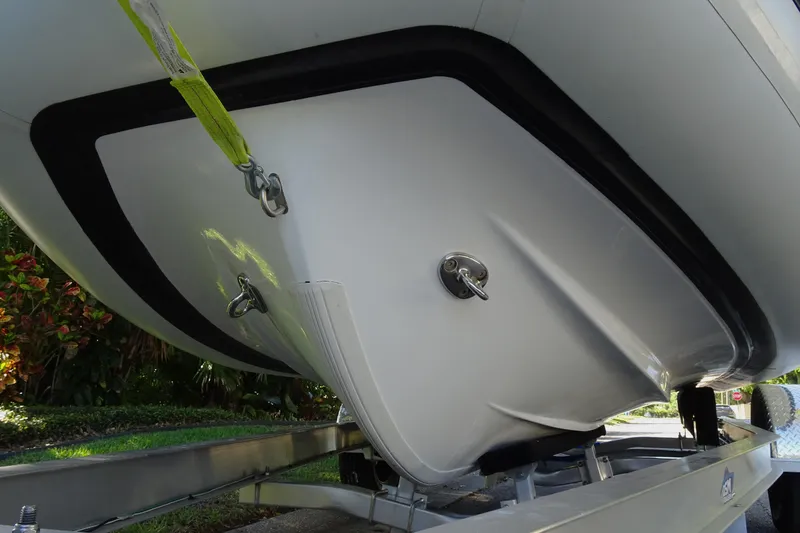 Slide: The Image of 2022 Walker Bay Generation 525 boat hull on trailer, showcasing sleek design and secure fittings. - 4