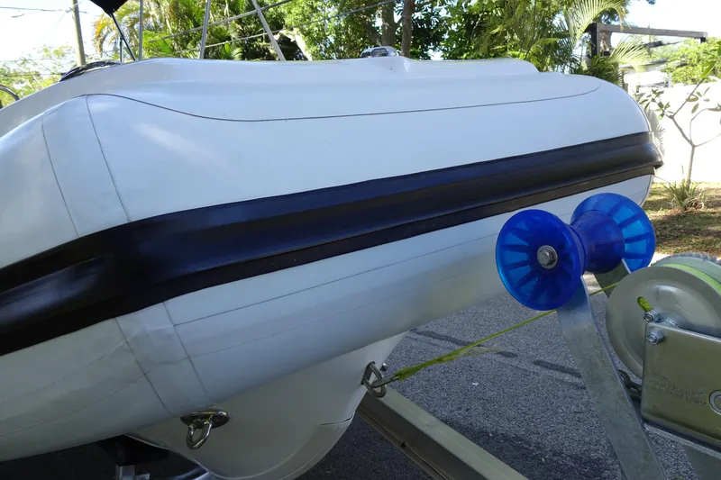 Slide: The Image of 2022 Walker Bay Generation 525 boat on trailer with blue rollers. - 9