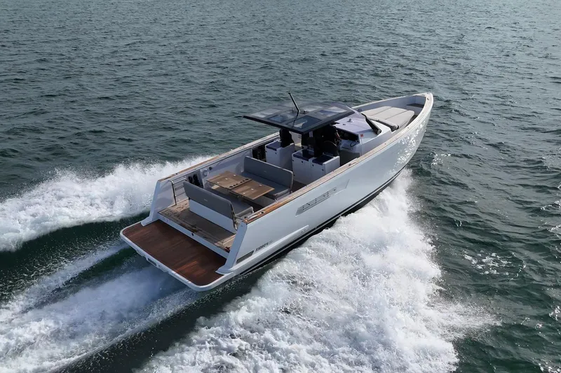 Slide: The Image of 2019 Fjord 40' Open yacht cruising on a sunny day with city skyline in background. - 11