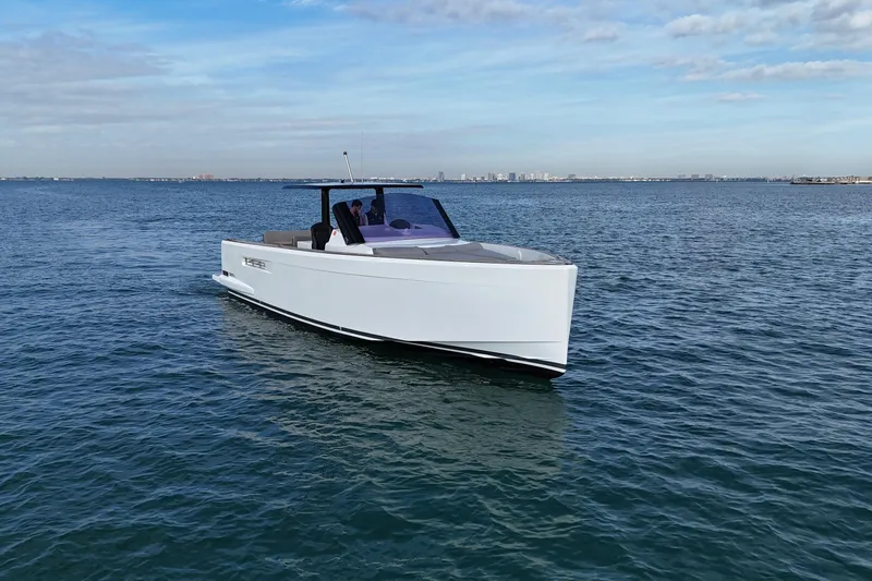 Slide: The Image of 2019 Fjord 40' Open yacht cruising on open water under a partly cloudy sky. - 18