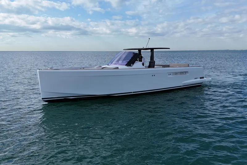 Slide: The Image of 2019 Fjord 40' Open yacht cruising on calm waters near luxury waterfront homes. - 20