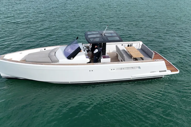 Slide: The Image of 2019 Fjord 40' Open yacht with sunbed, cruising on calm waters under a clear sky. - 24