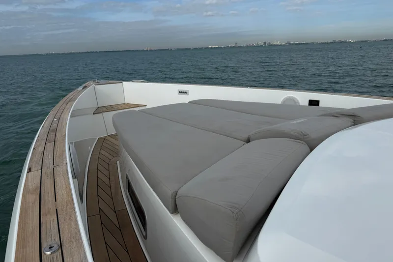 Slide: The Image of Luxury seating area on 2019 Fjord 40' Open yacht with wooden table and ocean view. - 27