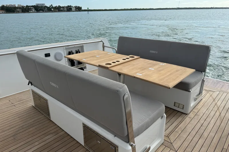 Slide: The Image of Luxury seating area on 2019 Fjord 40' Open yacht with wooden table, ocean view. - 28