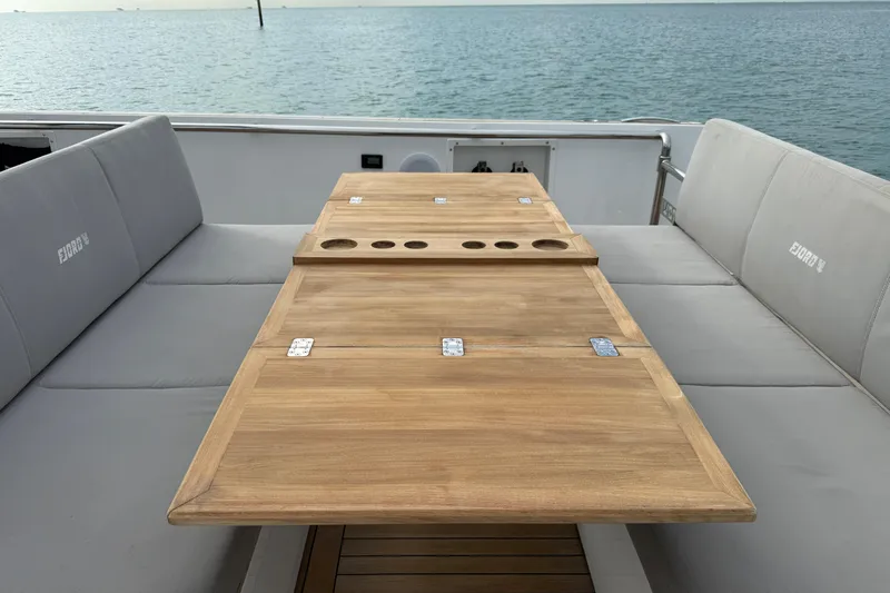 Slide: The Image of 2019 Fjord 40' Open yacht with sunshade, wooden deck, and seating, cruising on calm waters. - 29