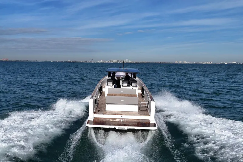 Slide: The Image of 2019 Fjord 40' Open yacht cruising on ocean with city skyline in background. - 7