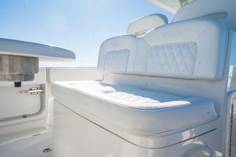 Slide: The Image of Luxurious seating on a 2019 Jupiter 38 HFS boat under clear blue skies. - 13