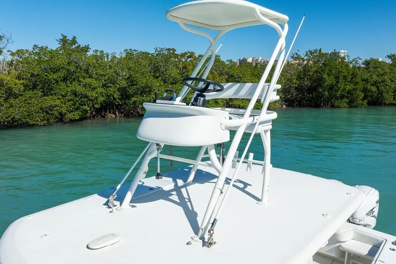 Slide: The Image of 2019 Jupiter 38 HFS boat with elevated helm, cruising in clear blue waters. - 16