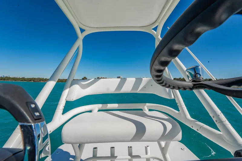 Slide: The Image of Cockpit view of 2019 Jupiter 38 HFS boat on clear blue water. - 21