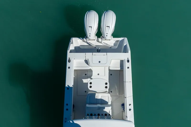 Slide: The Image of Overhead view of 2019 Jupiter 38 HFS boat with dual engines on turquoise water. - 24