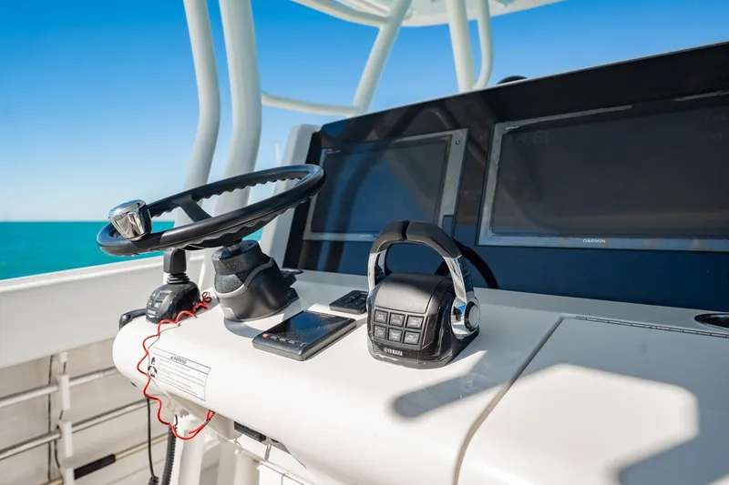 Slide: The Image of Control panel of a 2019 Jupiter 38 HFS boat with steering wheel and electronics. - 29