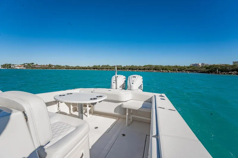 Slide: The Image of 2019 Jupiter 38 HFS boat on turquoise water with clear blue sky. - 34