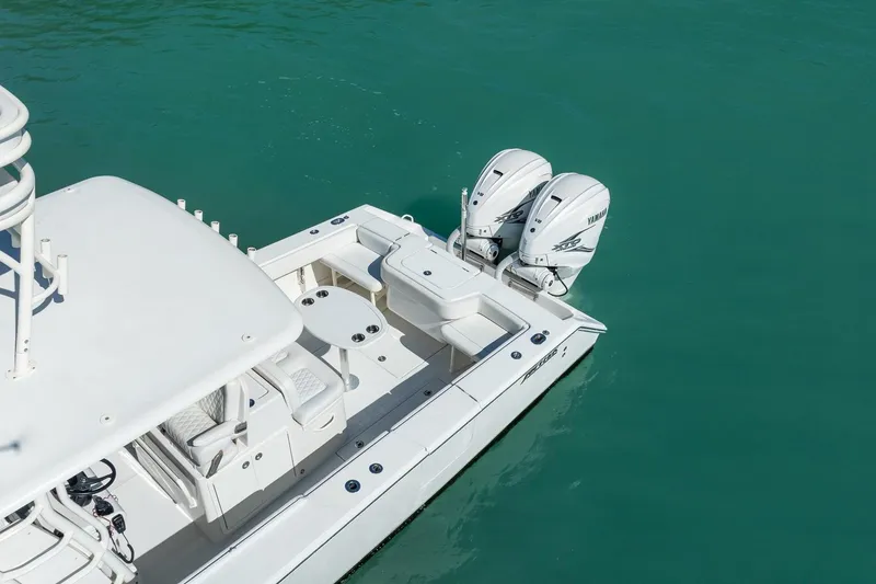 Slide: The Image of 2019 Jupiter 38 HFS boat with dual outboard engines on turquoise water. - 35