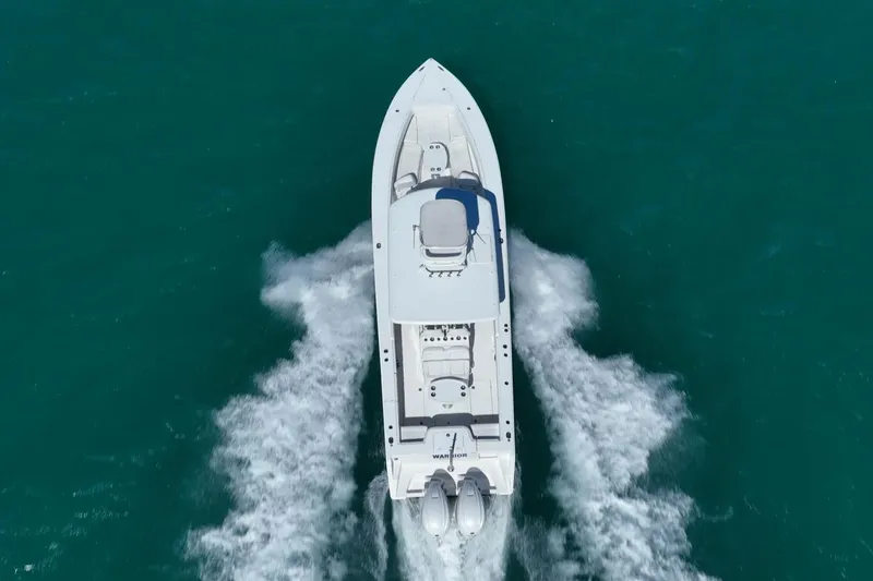 Slide: The Image of Aerial view of 2019 Jupiter 38 HFS boat cruising on turquoise water. - 41