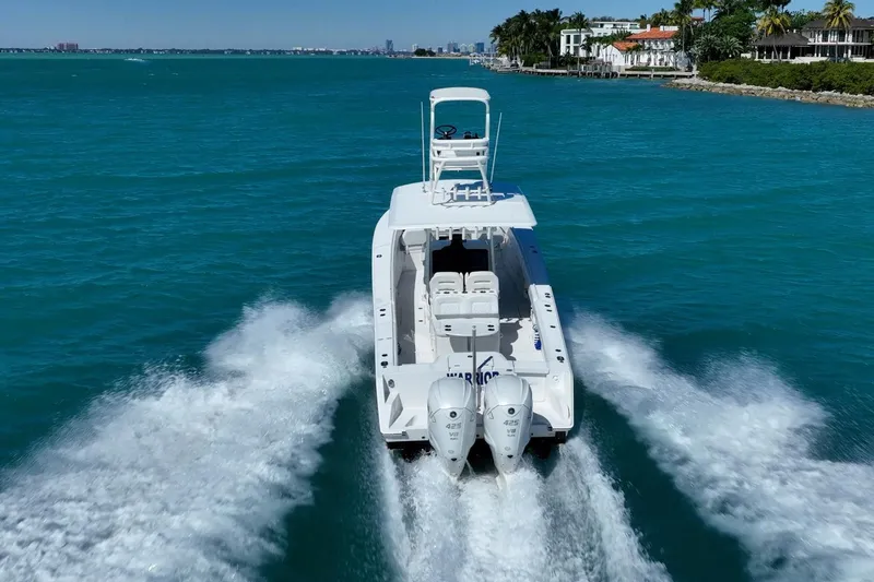 Slide: The Image of 2019 Jupiter 38 HFS boat cruising on turquoise waters near a coastal city. - 42
