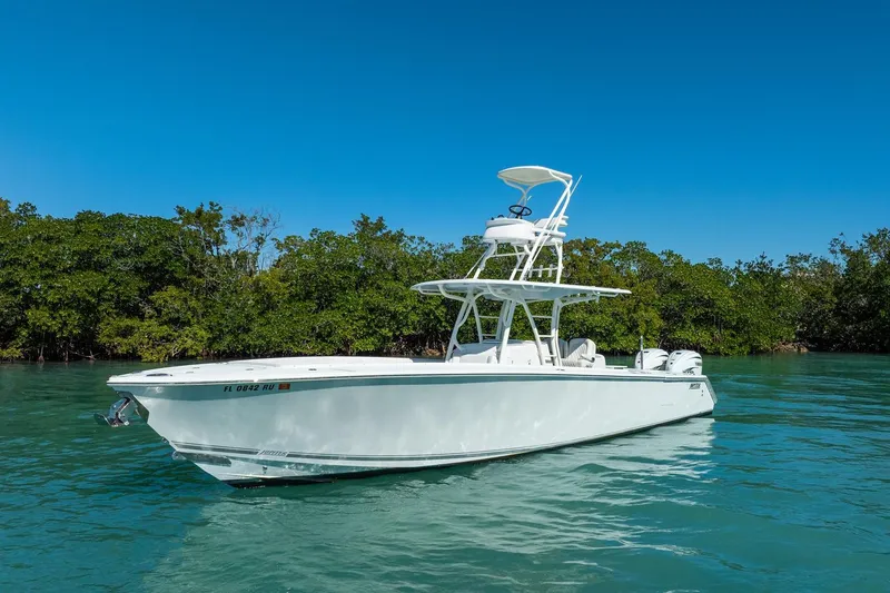 Slide: The Image of 2019 Jupiter 38 HFS boat on clear water with lush green background. - 5