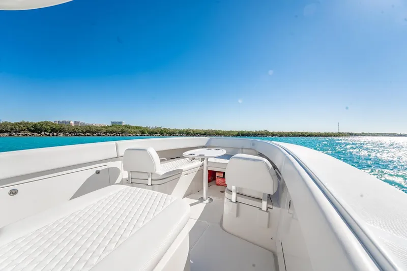 Slide: The Image of 2019 Jupiter 38 HFS boat interior with white seating, table, and ocean view. - 9