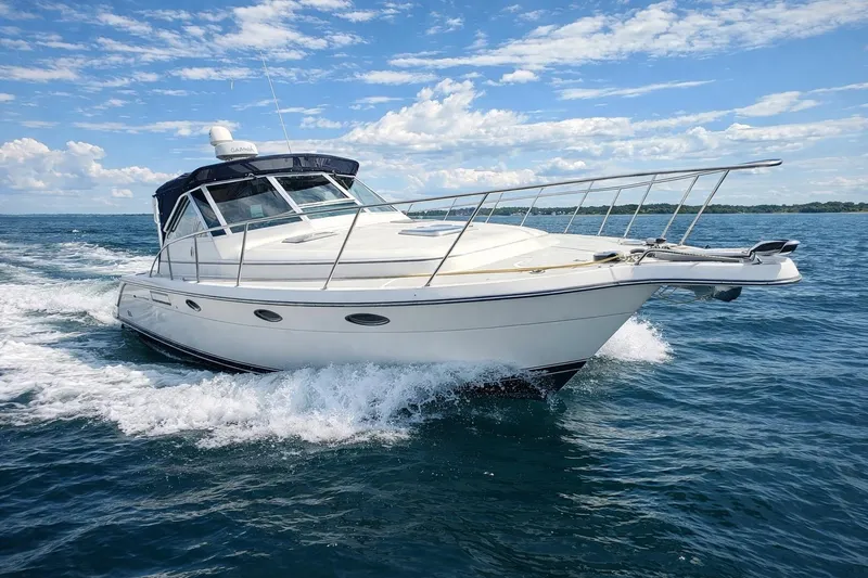 The Image of 1997 Tiara 3100 Open Express cruising on a sunny day with blue skies. - 0