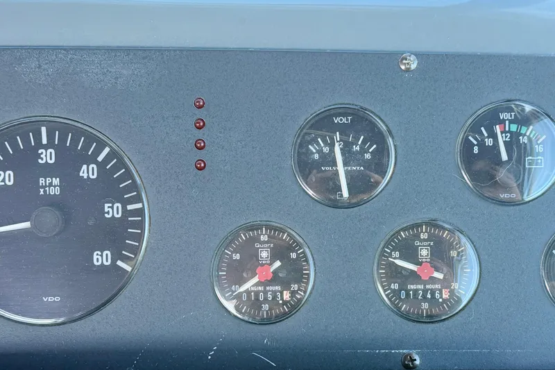 Slide: The Image of Dashboard of a 1997 Tiara 3100 Open Express with RPM and volt gauges. - 11