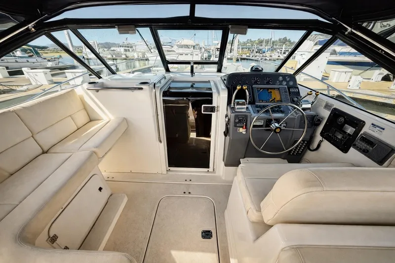 Slide: The Image of Interior of a 1997 Tiara 3100 Open Express boat with helm and seating area. - 12