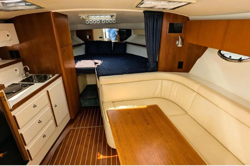 Slide: The Image of Interior of a 1997 Tiara 3100 Open Express yacht with kitchen and seating area. - 16