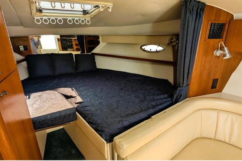 Slide: The Image of Interior cabin of a 1997 Tiara 3100 Open Express yacht with cozy bedding. - 17
