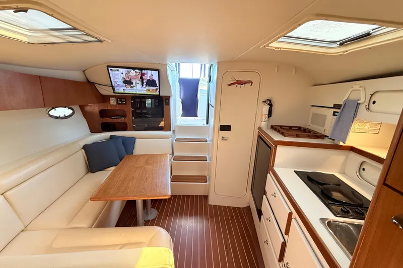 Slide: The Image of Interior of a 1997 Tiara 3100 Open Express yacht with kitchen and seating area. - 19