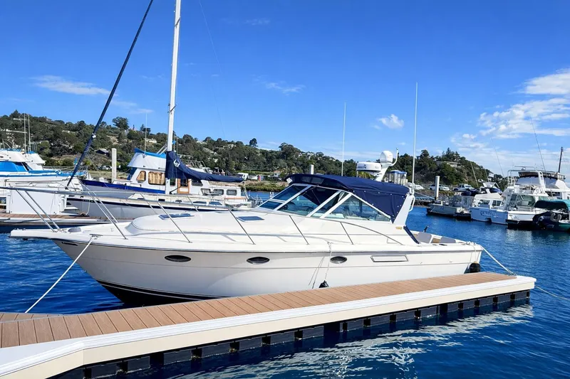 Slide: The Image of 1997 Tiara 3100 Open Express yacht docked at marina under clear blue sky. - 2