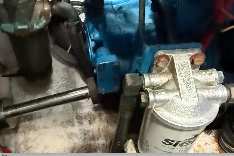 Slide: The Image of Engine compartment of a 1997 Tiara 3100 Open Express boat, showing mechanical components. - 28