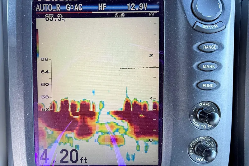 Slide: The Image of Fishfinder display on a 1997 Tiara 3100 Open Express, showing underwater depth and temperature. - 9