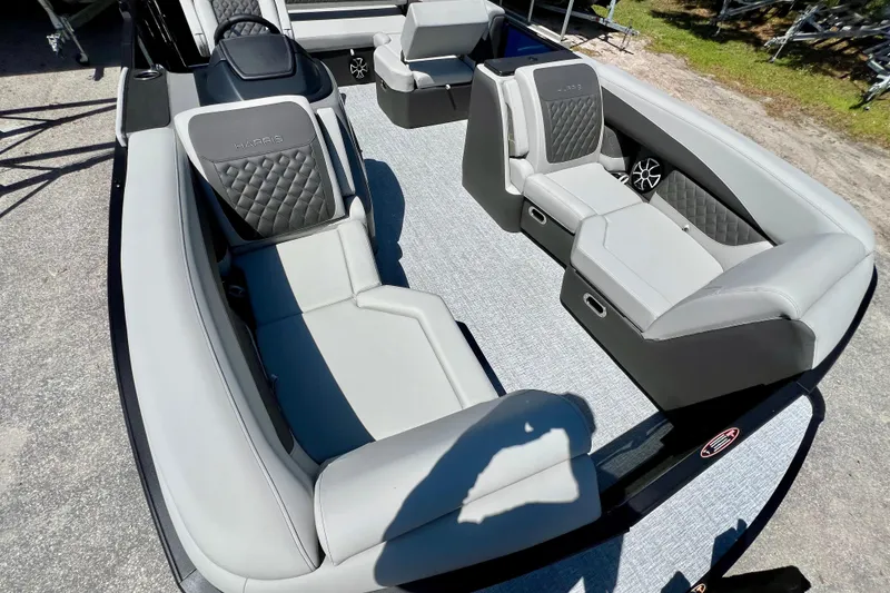 Slide: The Image of 2026 Harris Sunliner 210 boat interior with luxurious gray seating and modern design. - 10