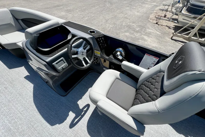Slide: The Image of Interior view of 2026 Harris Sunliner 210 boat, featuring modern helm and comfortable seating. - 14
