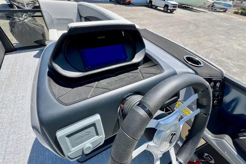 Slide: The Image of 2026 Harris Sunliner 210 dashboard with steering wheel and digital display. - 15