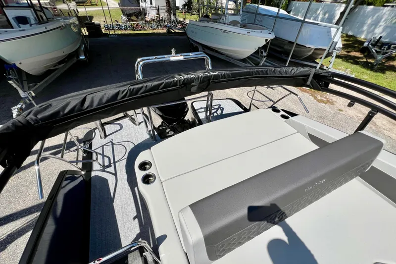 Slide: The Image of 2026 Harris Sunliner 210 pontoon boat interior with seating and cup holders. - 18