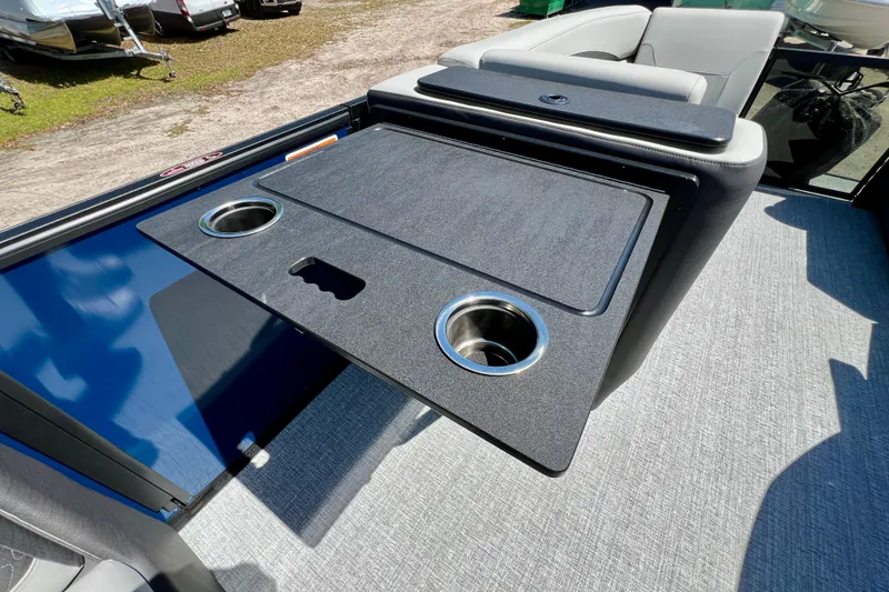 Slide: The Image of Interior of 2026 Harris Sunliner 210 boat with cup holders and seating area. - 20
