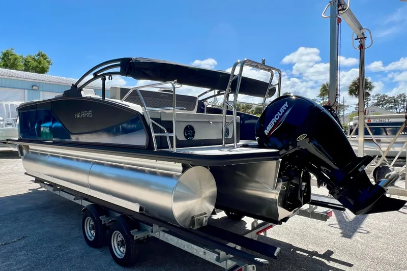 Slide: The Image of 2026 Harris Sunliner 210 pontoon boat with Mercury outboard motor on trailer. - 6