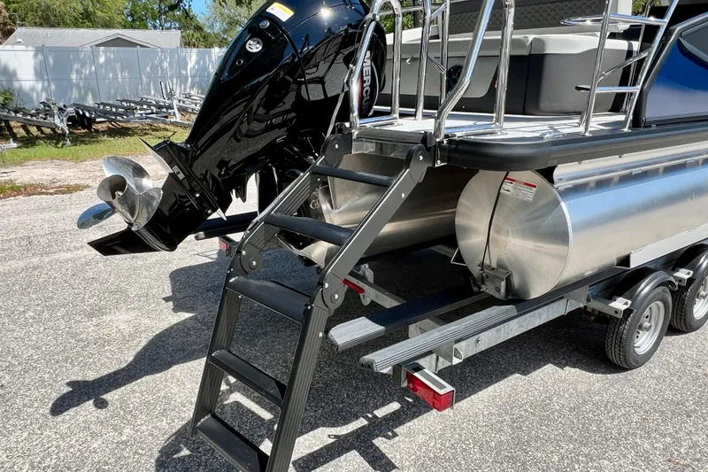 Slide: The Image of 2026 Harris Sunliner 210 pontoon boat with Mercury outboard engine on trailer. - 9