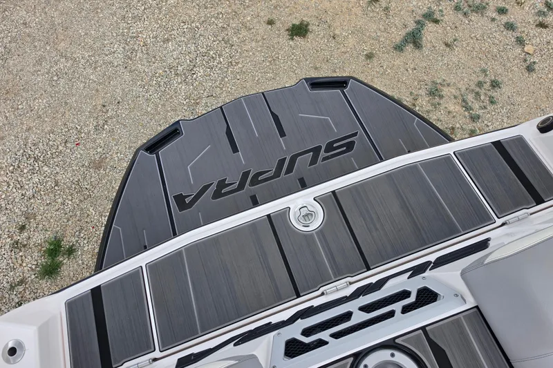 Slide: The Image of 2023 Supra SL 450 boat deck with sleek black and gray design. - 11