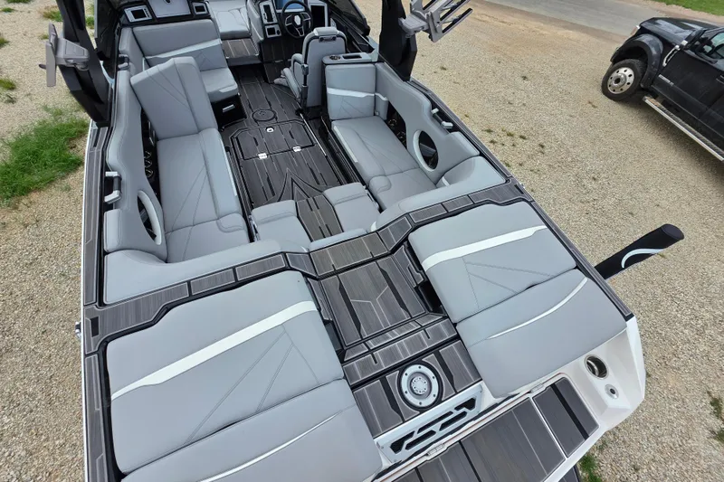 Slide: The Image of 2023 Supra SL 450 boat interior with sleek gray seating and modern design. - 12