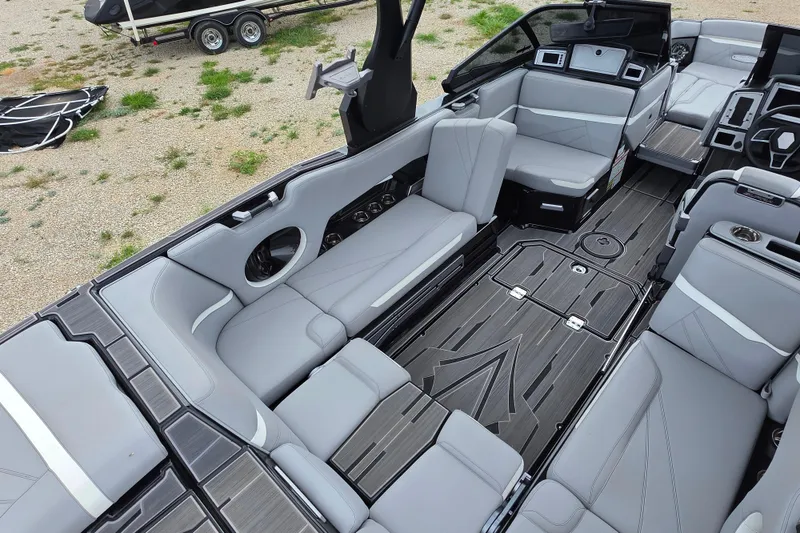 Slide: The Image of 2023 Supra SL 450 boat interior with sleek gray seating and modern design. - 14