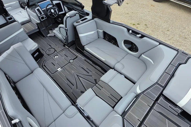 Slide: The Image of Luxurious interior of 2023 Supra SL 450 boat with sleek gray seating and modern dashboard. - 15